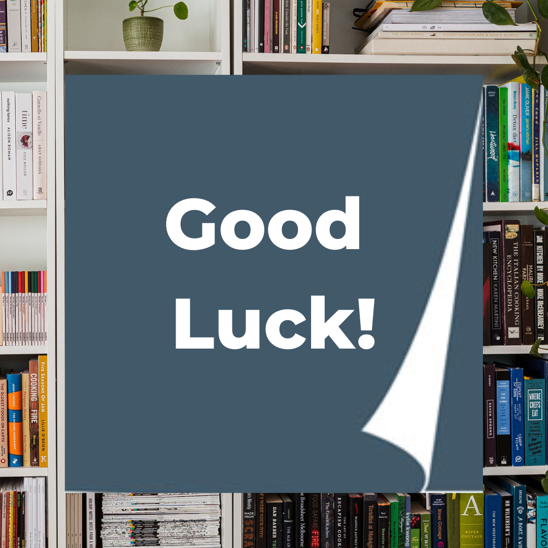 The words 'Good Luck' appear in white on a navy blue square. A full bookshelf is in the background.